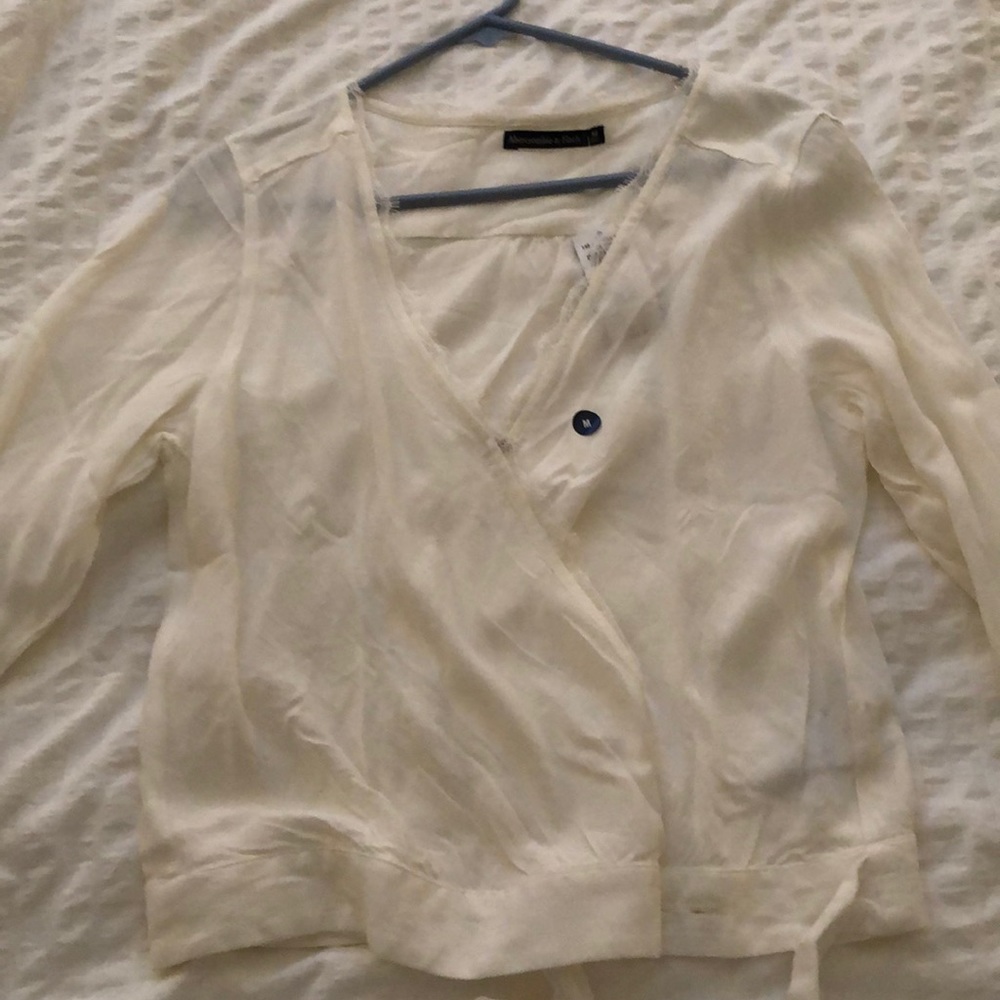 White long sleeve shirt with lace and a tie